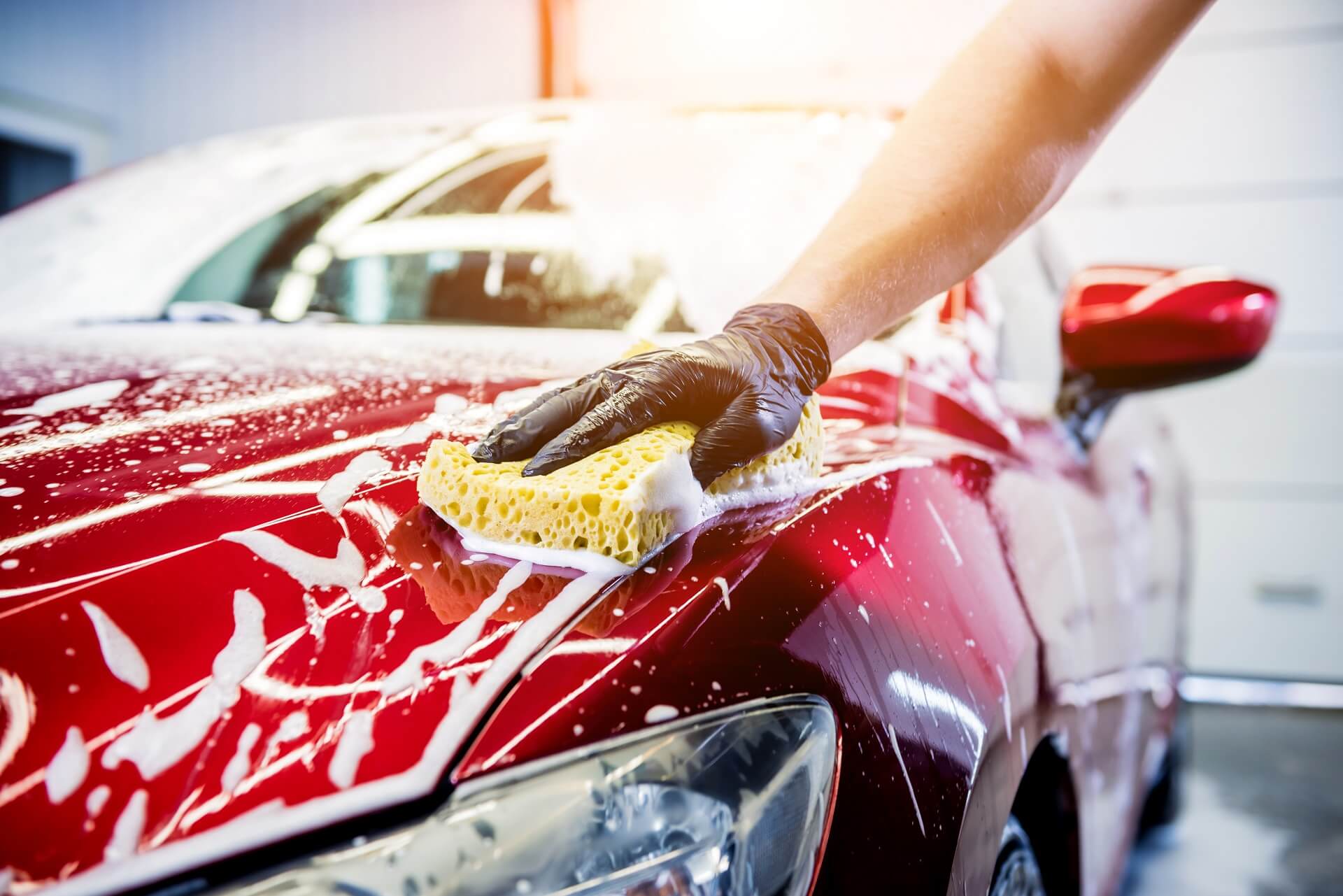 3----worker-washing-red-car-with-sponge-car-wash (1)